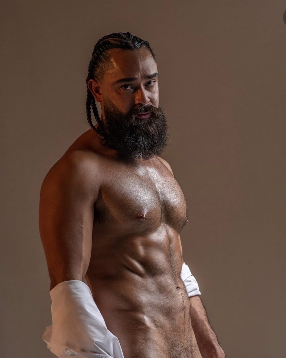 Cocks and Camels male exotic entertainer in dramatic low-key lighting